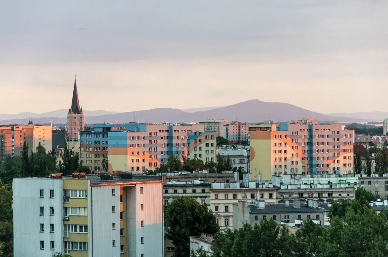 Widok na Wrocławskie osiedla z górami w tle. Zastanawiasz się, jakie góry widać z Wrocławia? To Ślęża i inne pasma Sudetów.