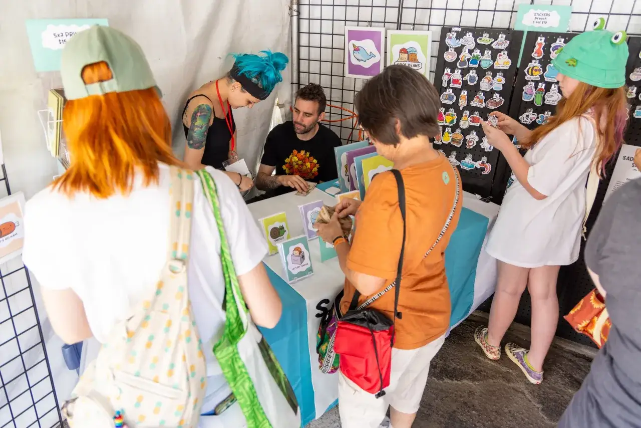 Discover how to find up and coming artists at this vibrant market stall, featuring cute prints and stickers.