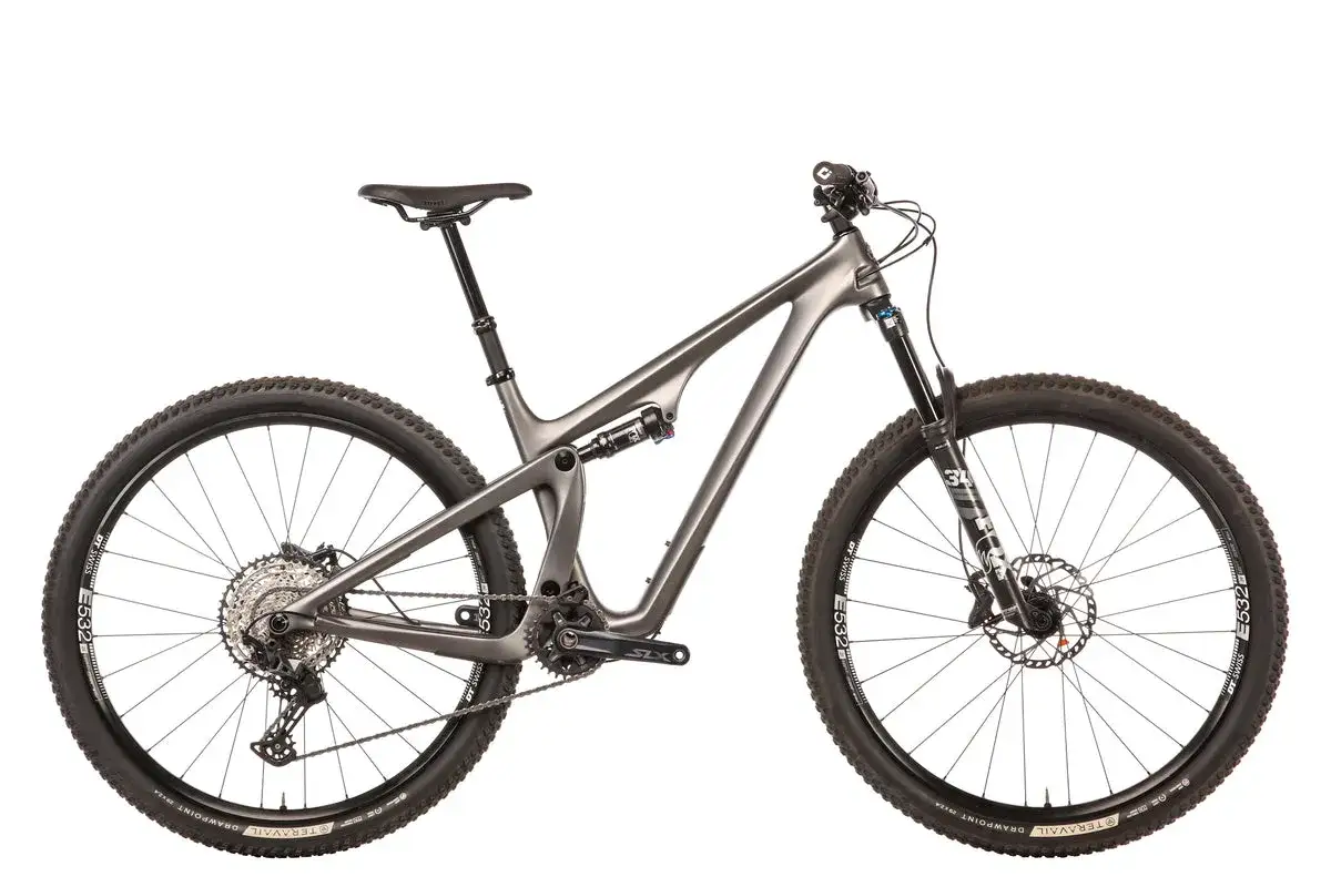 A sleek, grey full-suspension mountain bike, ready for any trail. Its diamondback recoil design ensures a smooth ride over rough terrain.