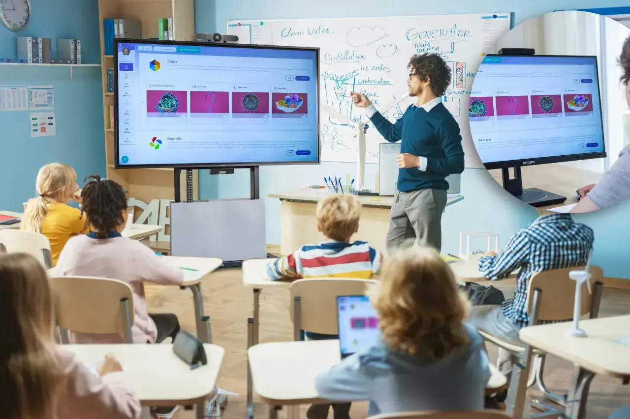 Lehrer erklärt am Whiteboard, während Schüler im **hybrid unterricht** auf Bildschirme schauen.