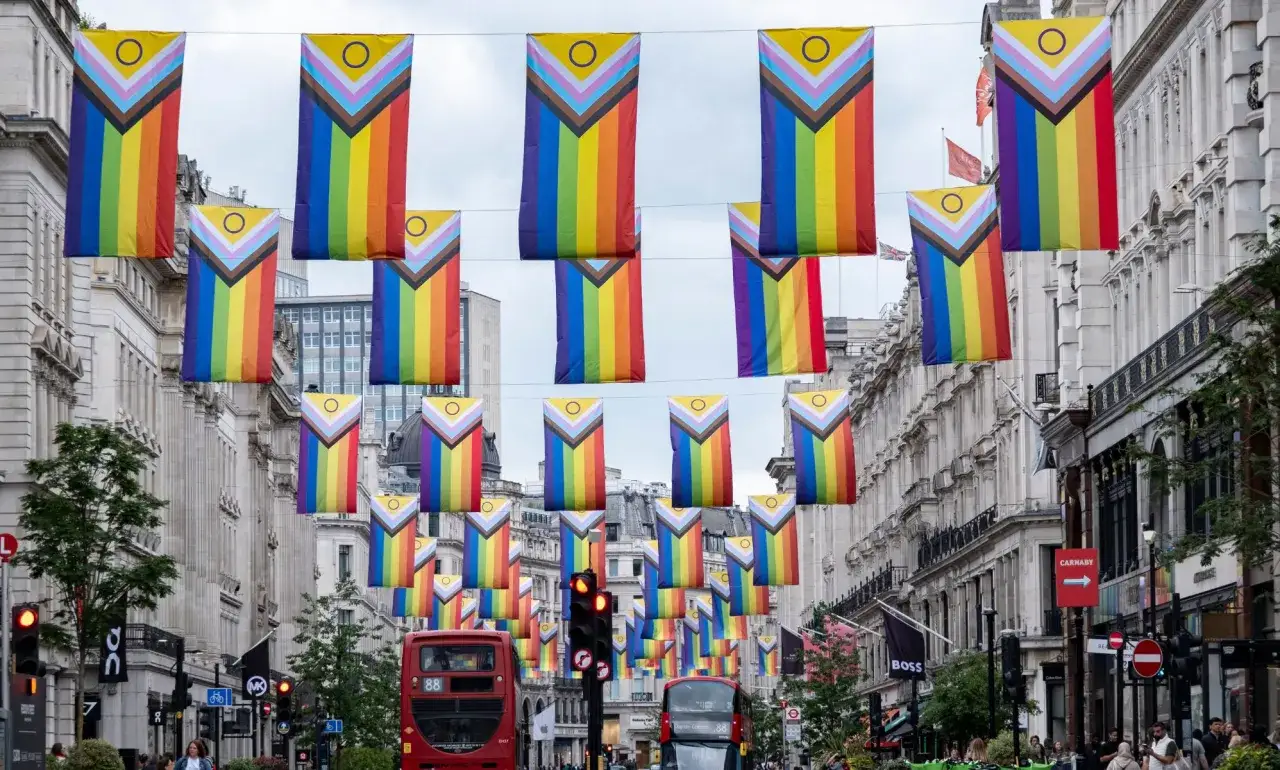 Rainbow flags adorn a street, signaling a vibrant and gay friendly place to live.