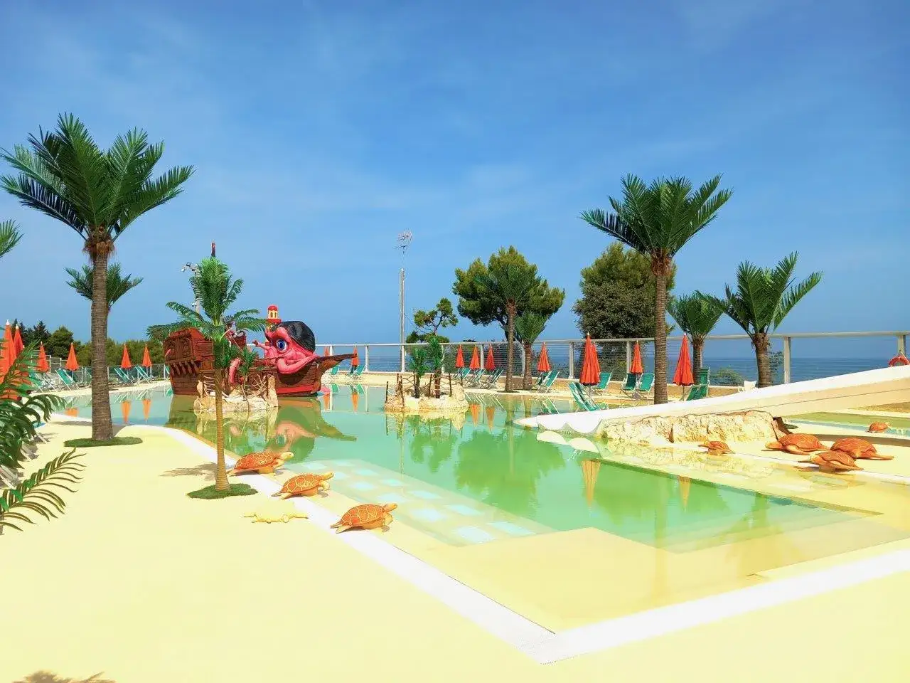 Piscina con nave pirata e tartarughe, ideale per famiglie. Ottime recensioni per il villaggio Riva Verde Marche.