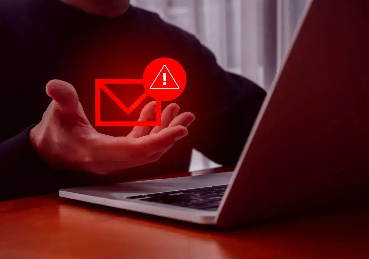 Dłoń trzyma symbol wiadomości z czerwonym ostrzeżeniem, sugerując problem z firmantwem.