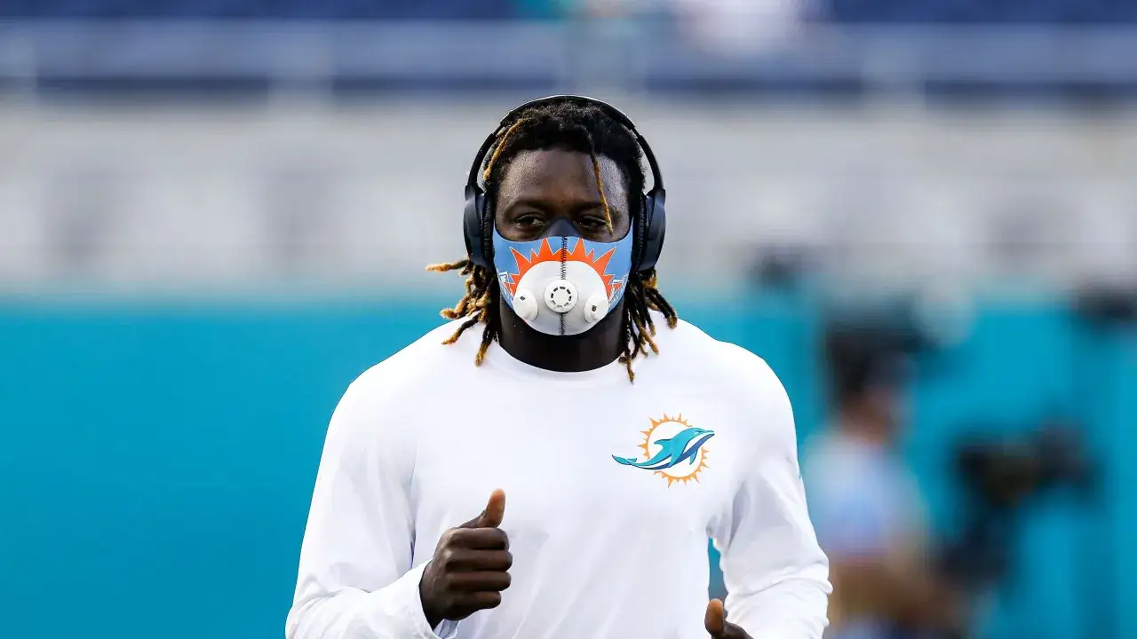 Miami Dolphins player training with an oxygen restriction mask, exploring its benefits for enhanced performance and endurance.