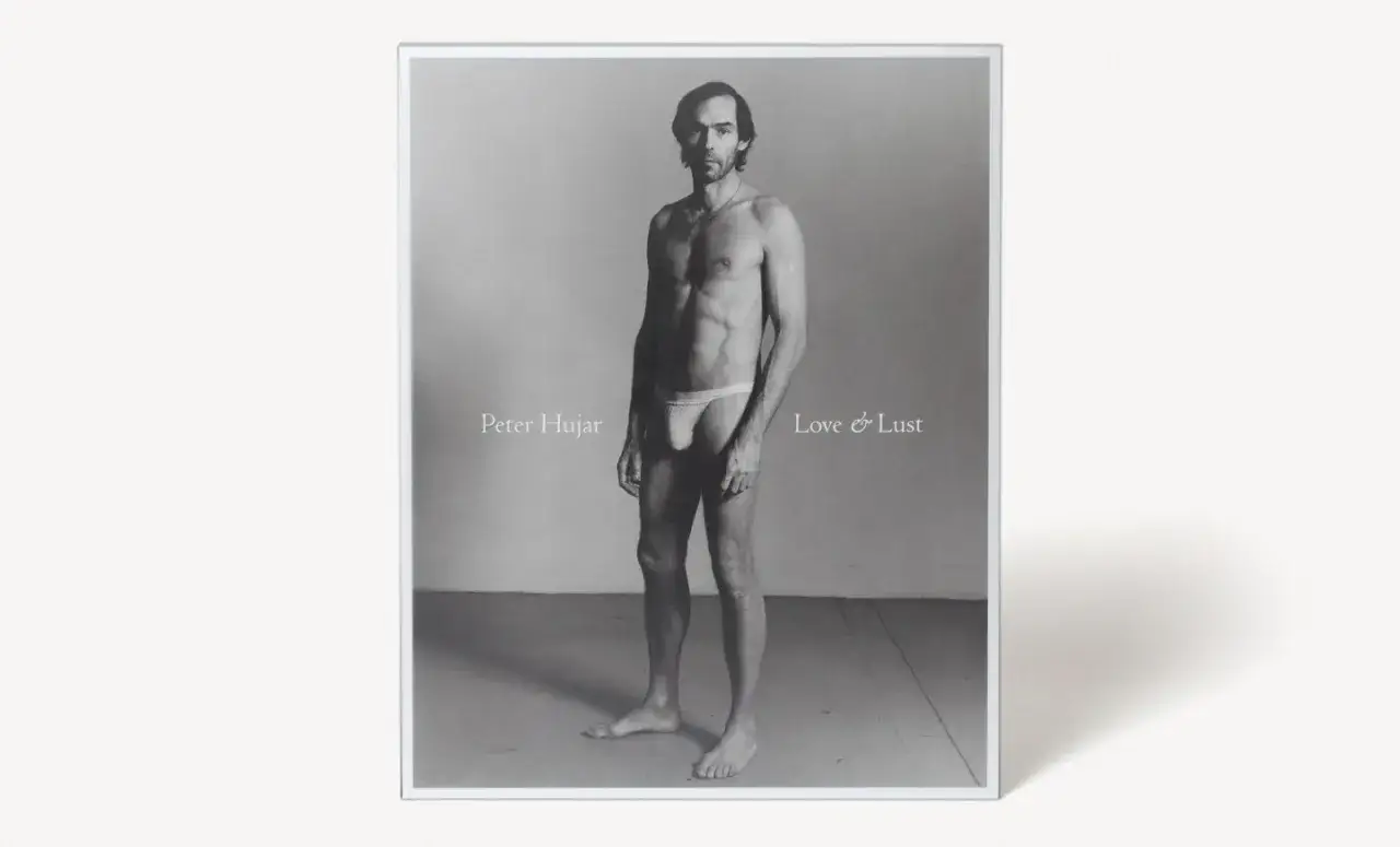 A black and white portrait of a man in a jockstrap, titled
