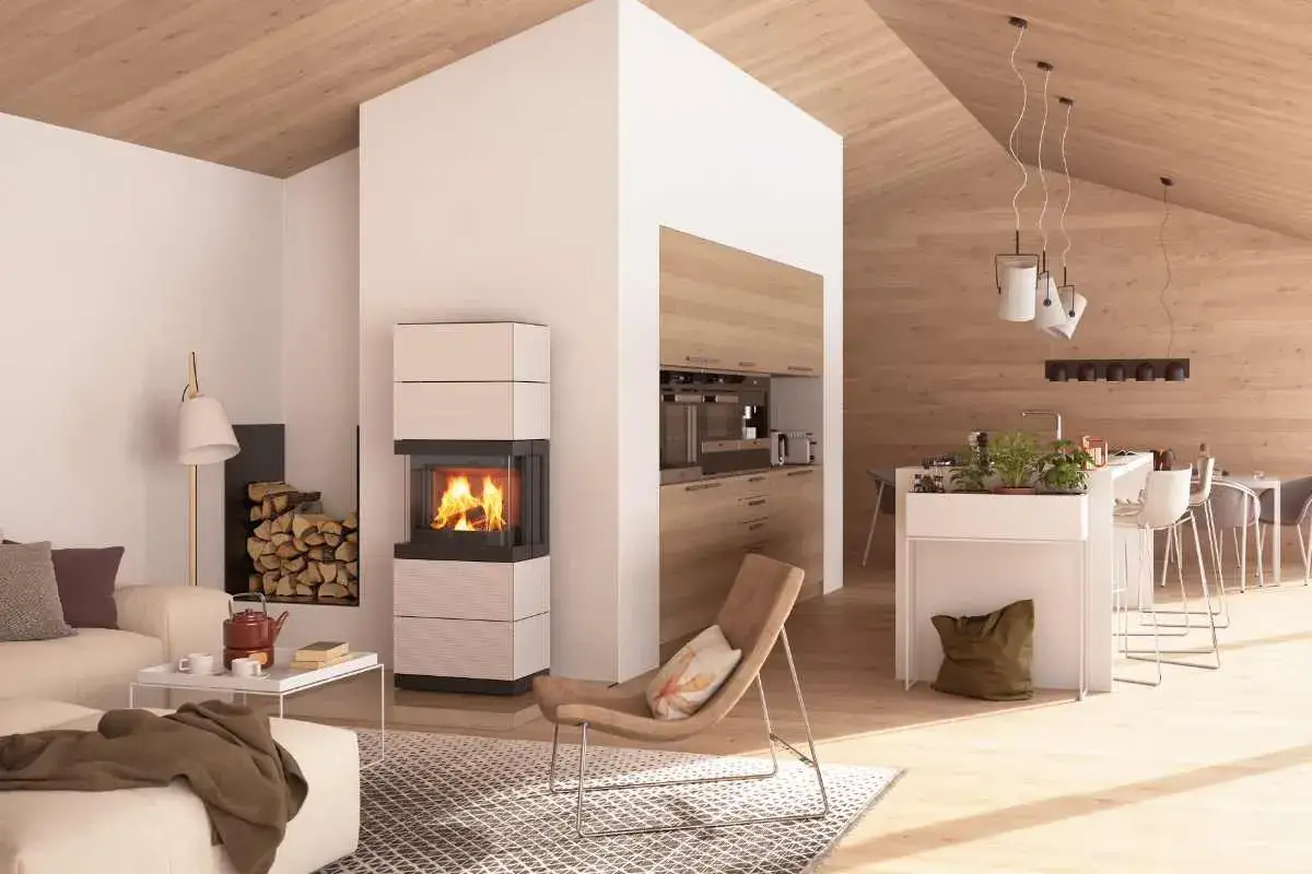 Un poêle à granulés moderne, aux dimensions élégantes, réchauffe ce salon-cuisine lumineux avec son feu vif.