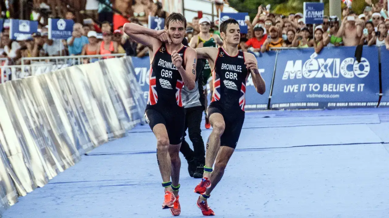 Two athletes in Great Britain tri suits run side-by-side, a scene that could inspire any beginner triathlon participant.