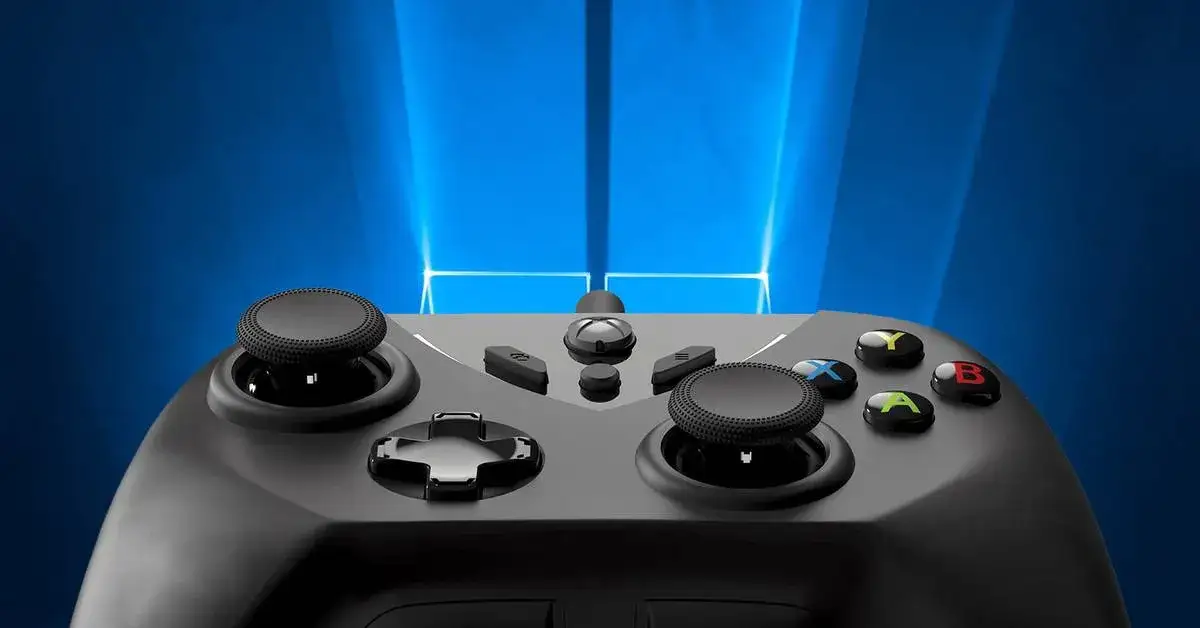 Szary pad Xbox z przyciskami A, B, Y, X i krzyżakiem. Idealny do gier na PC. Dowiedz się, jak podłączyć pada Xbox do PC.