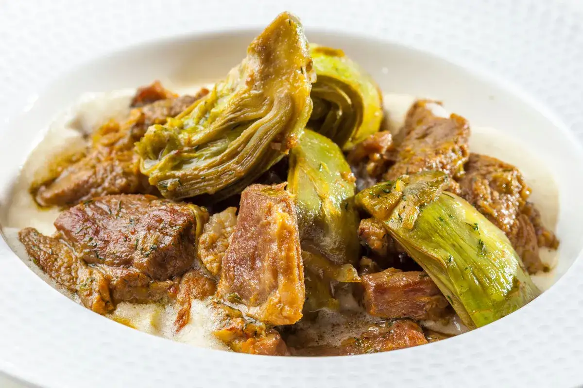 Un saporito agnello con carciofi in umido, un piatto tradizionale che profuma di casa.