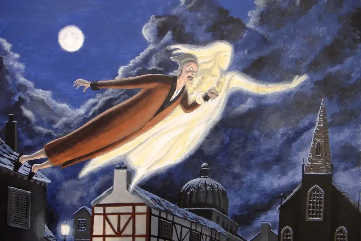 Duch Wigilijnej Opowieści unosi Ebenezera Scrooge'a nad nocnym miastem.