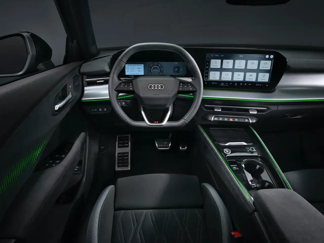 Wnętrze Audi Q3 2025 z nowoczesnym ekranem dotykowym i cyfrowymi zegarami.