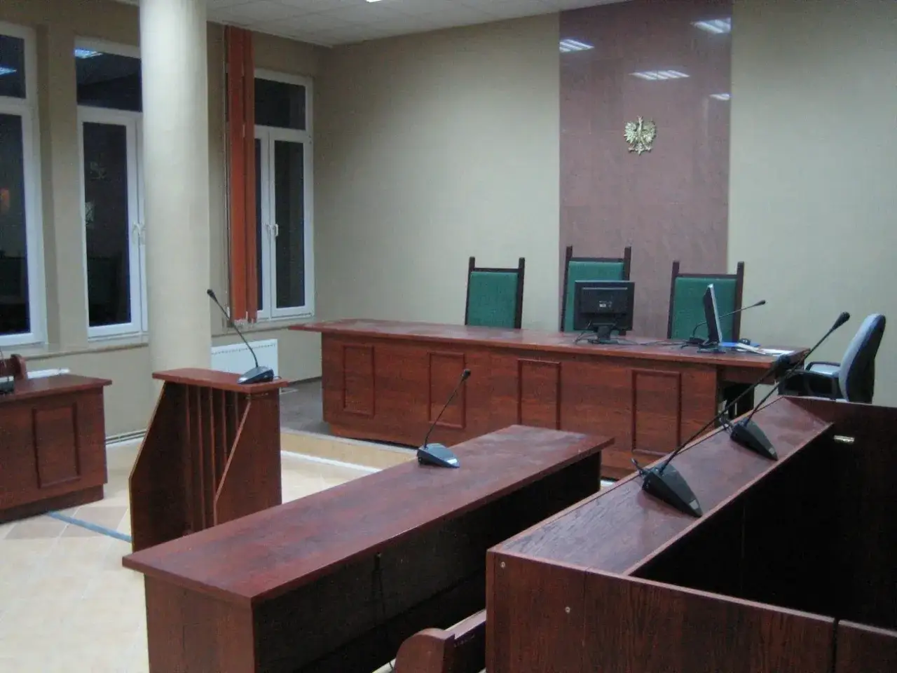Pusta sala sądowa, gotowa na ostatnią rozprawę w sprawie upadłości konsumenckiej.