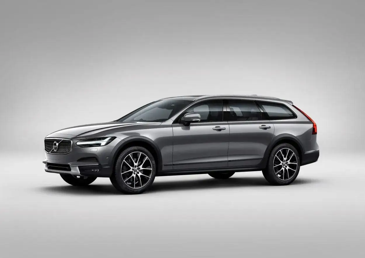 Szary Volvo Cross Country z czarnymi nakładkami na błotniki i felgami stoi na tle.