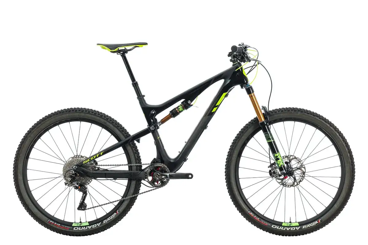 A black and yellow 2016 Scott Genius full-suspension mountain bike with Fox suspension and Vittoria tires, ready for any trail.