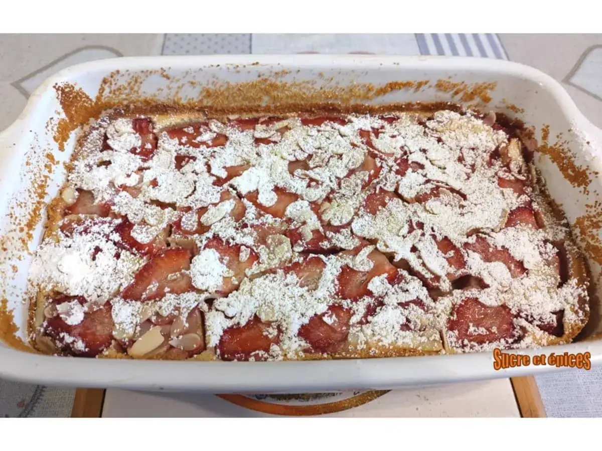 Clafoutis aux fraises tout juste sorti du four, saupoudr&eacute; de sucre glace et d'amandes effil&eacute;es. Un d&eacute;lice !