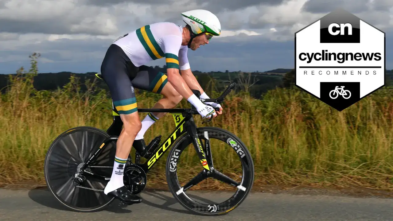 A cyclist in Australian colors races a tt bike, showcasing the speed difference compared to a road bike.