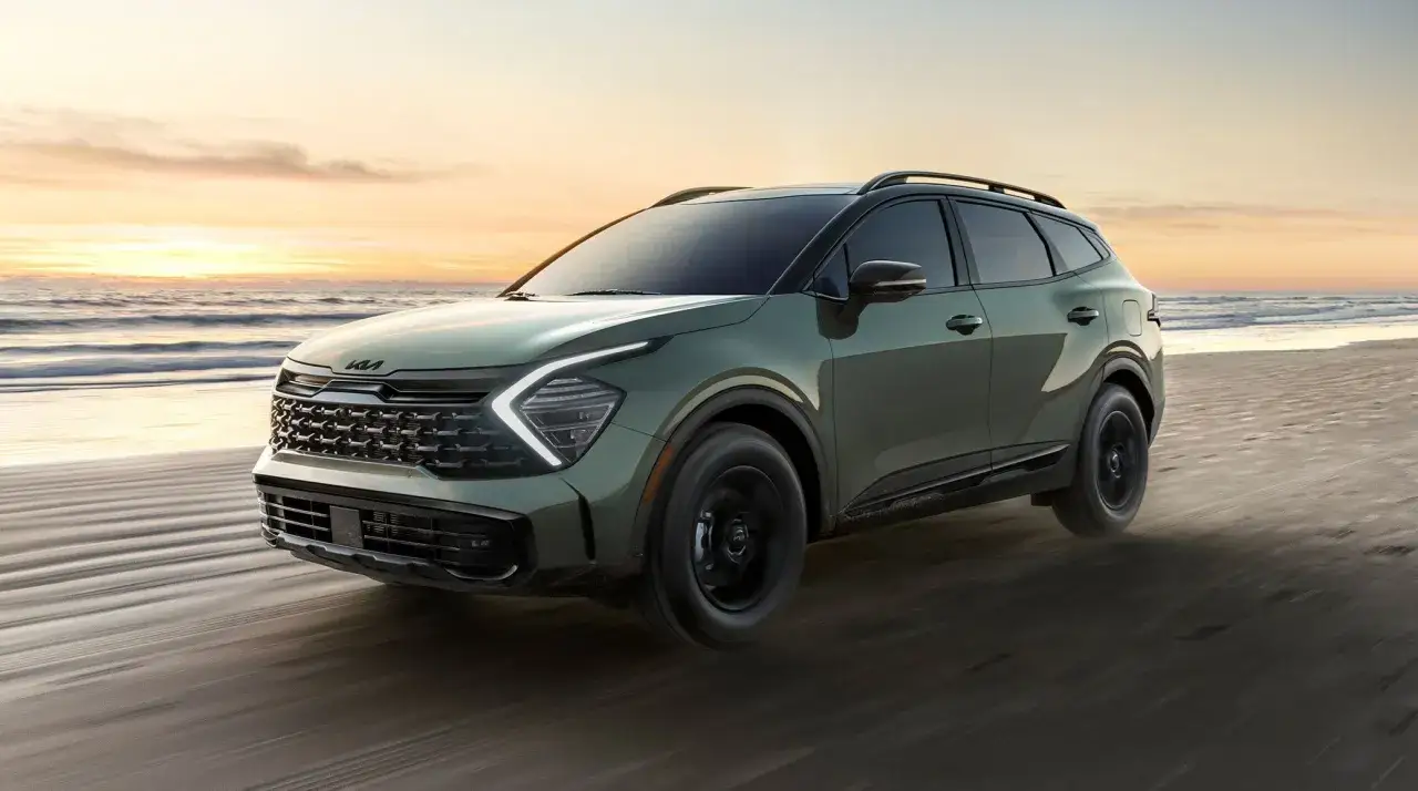 Kia Sportage verde en la playa al atardecer. ¿Buscas información en un foro Kia Sportage problemas?