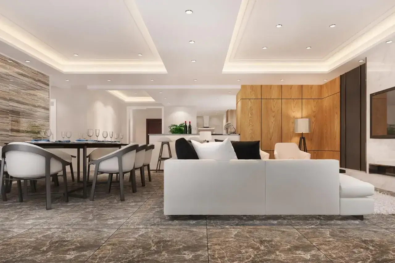 Nowoczesny salon z jadalnią, gdzie subtelne światło wydobywa się z listwy led wpuszczanej w sufit, tworząc przytulną atmosferę.
