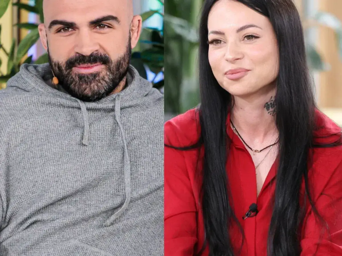 Akop i Sylwia Szostak uśmiechają się do obiektywu. On w szarej bluzie, ona w czerwonej koszuli.