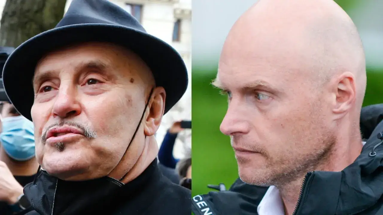 Krzysztof Igor Krawczyk w kapeluszu i łysy mężczyzna patrzą w różne strony.
