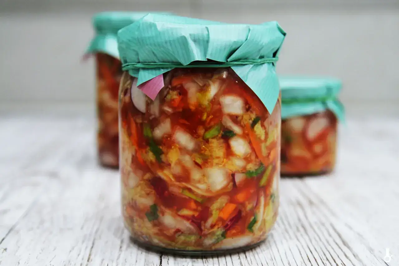 Słoiki z domowym kimchi, idealne na przepis na kimchi po polsku. Fermentowane warzywa w pikantnej zalewie.