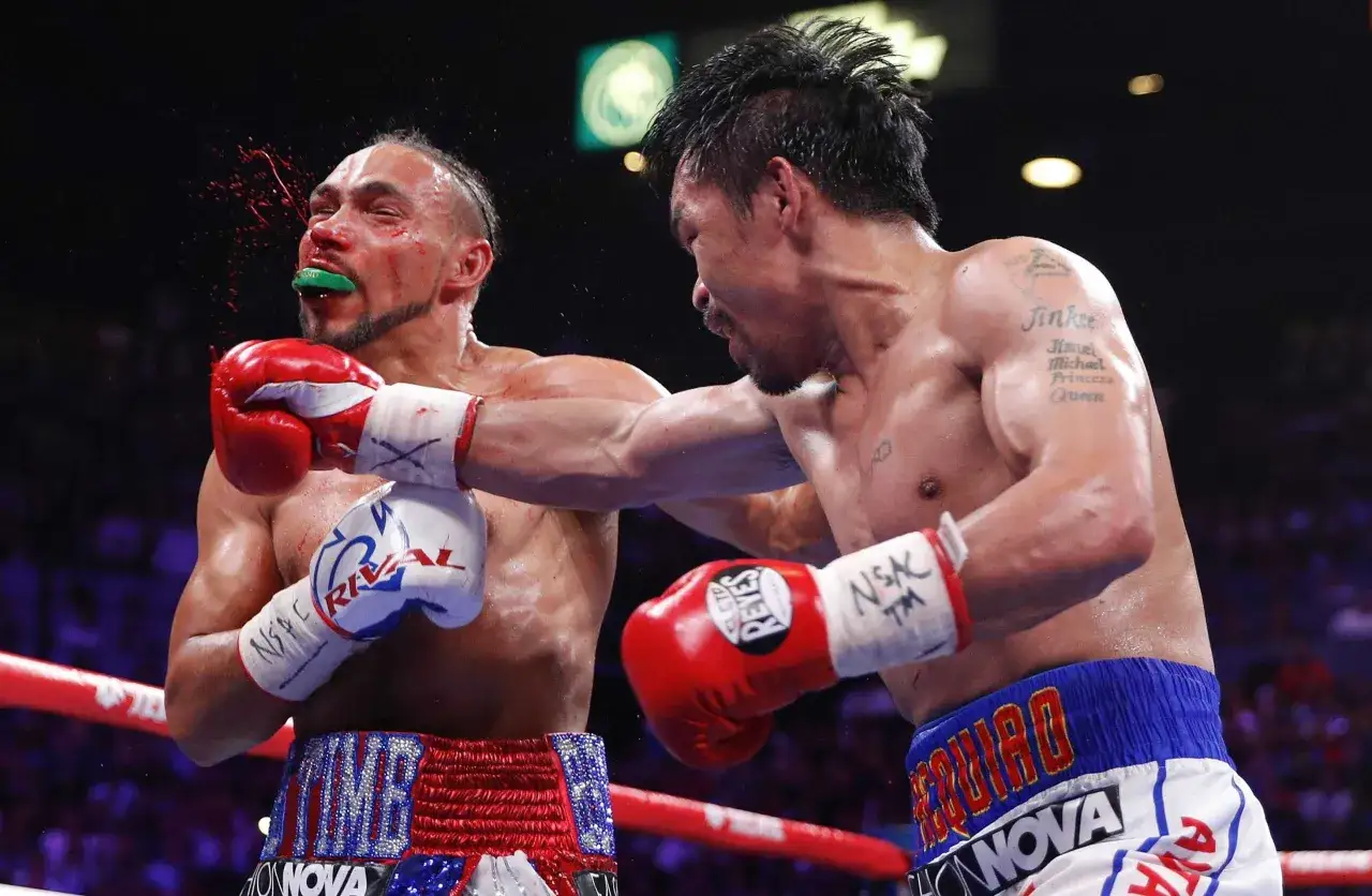 Manny Pacquiao lands a powerful punch, demonstrating how to counter punch effectively. Blood sprays from his opponent's face.