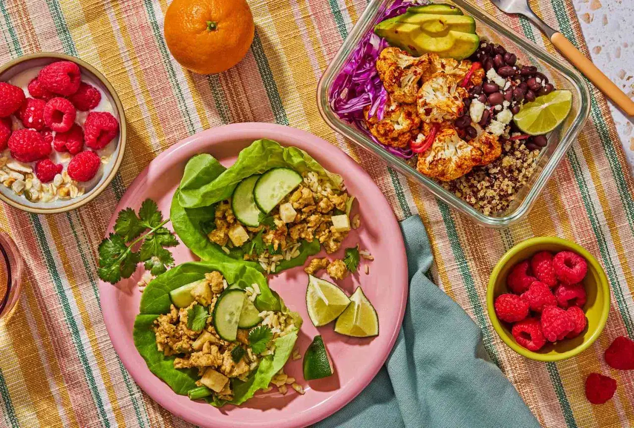 Sałatki z kurczaka w liściach sałaty, miseczka z malinami i owsianką, pomarańcza i lunchbox z kalafiorem. Czy to jest to, o co pytasz, oxy co to?