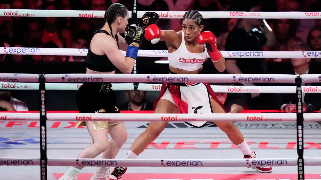 Two female boxers face off in the ring. The bout is intense, with each fighter aiming to win all the rounds in boxing.