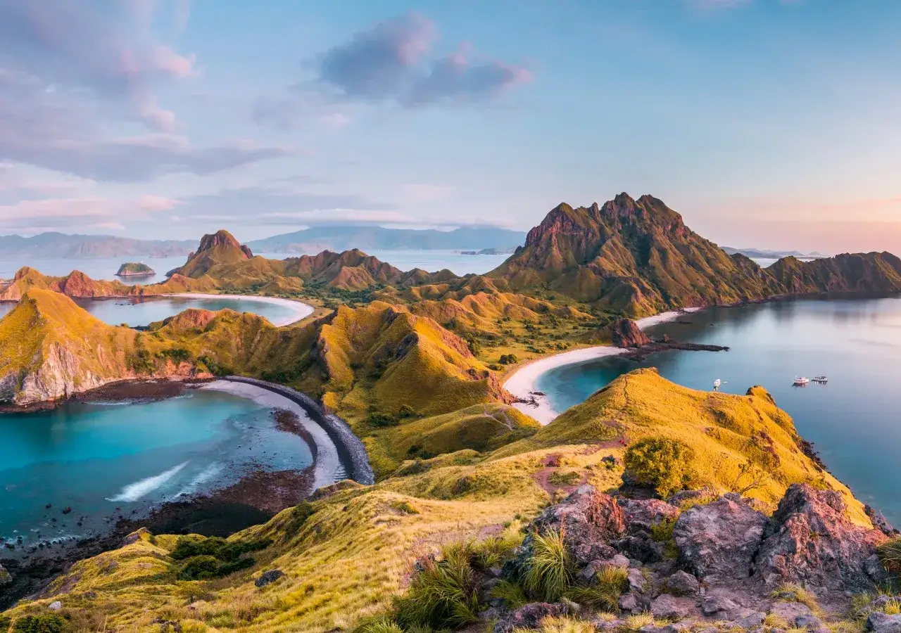 Atemberaubende Aussicht auf die Hügel und Buchten des Komodo Nationalparks bei Sonnenuntergang.