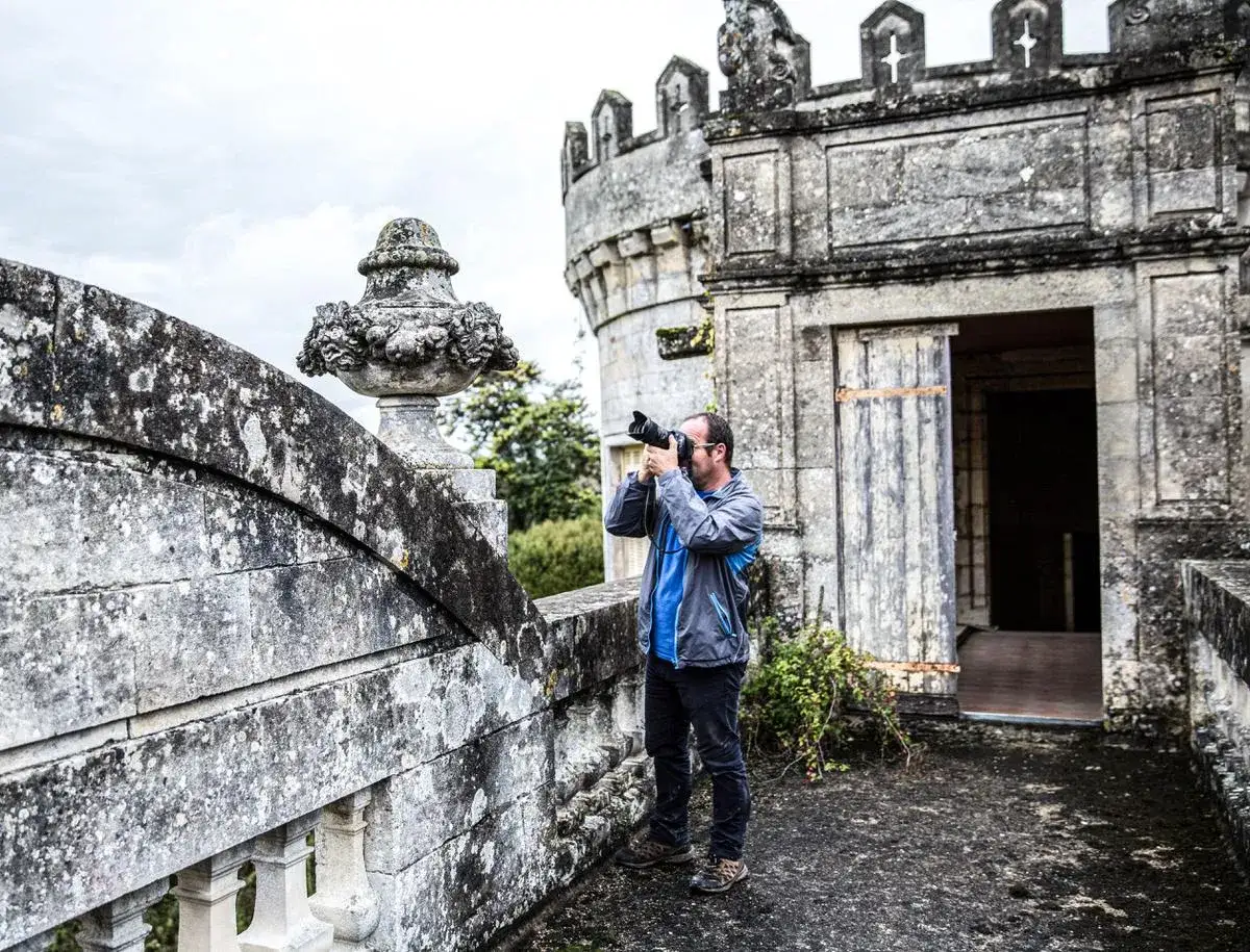 Photographe en exploration urbex au Pays Basque, capturant la beauté délabrée d'un château.
