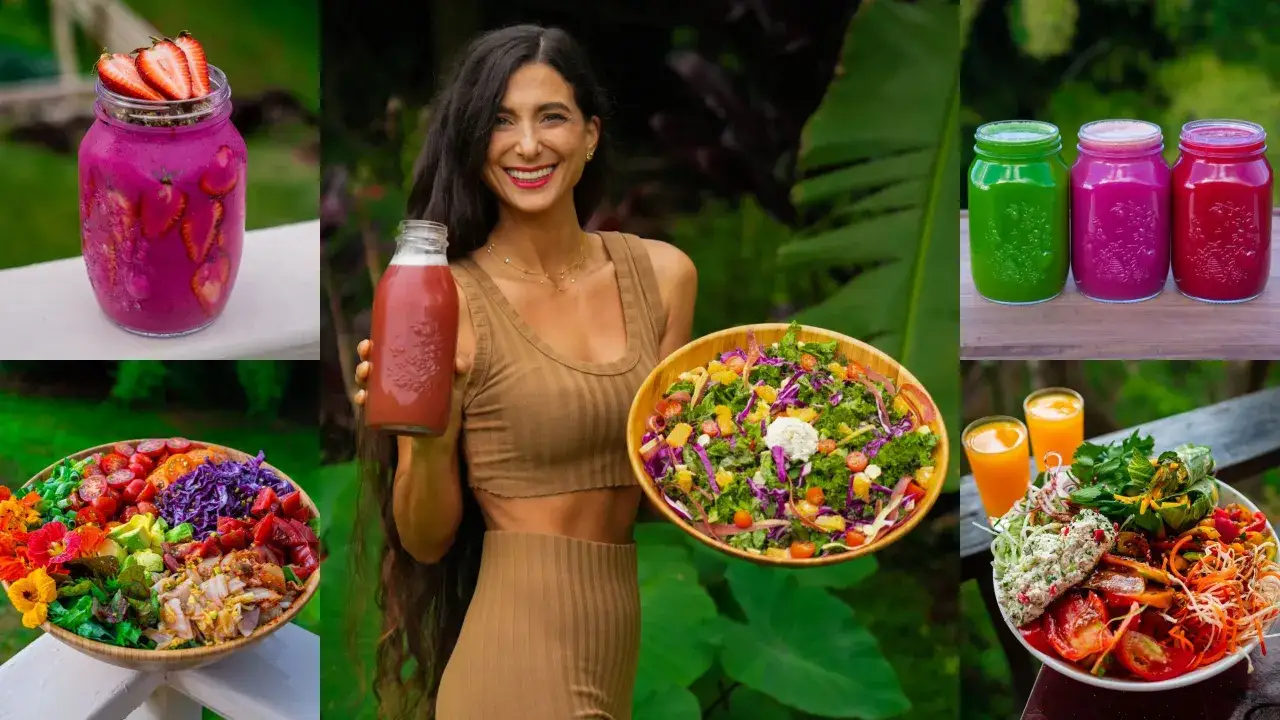 Uśmiechnięta kobieta z butelką soku, obok kolorowe sałatki i smoothie. To uczta dla zwolenników witarianizmu.