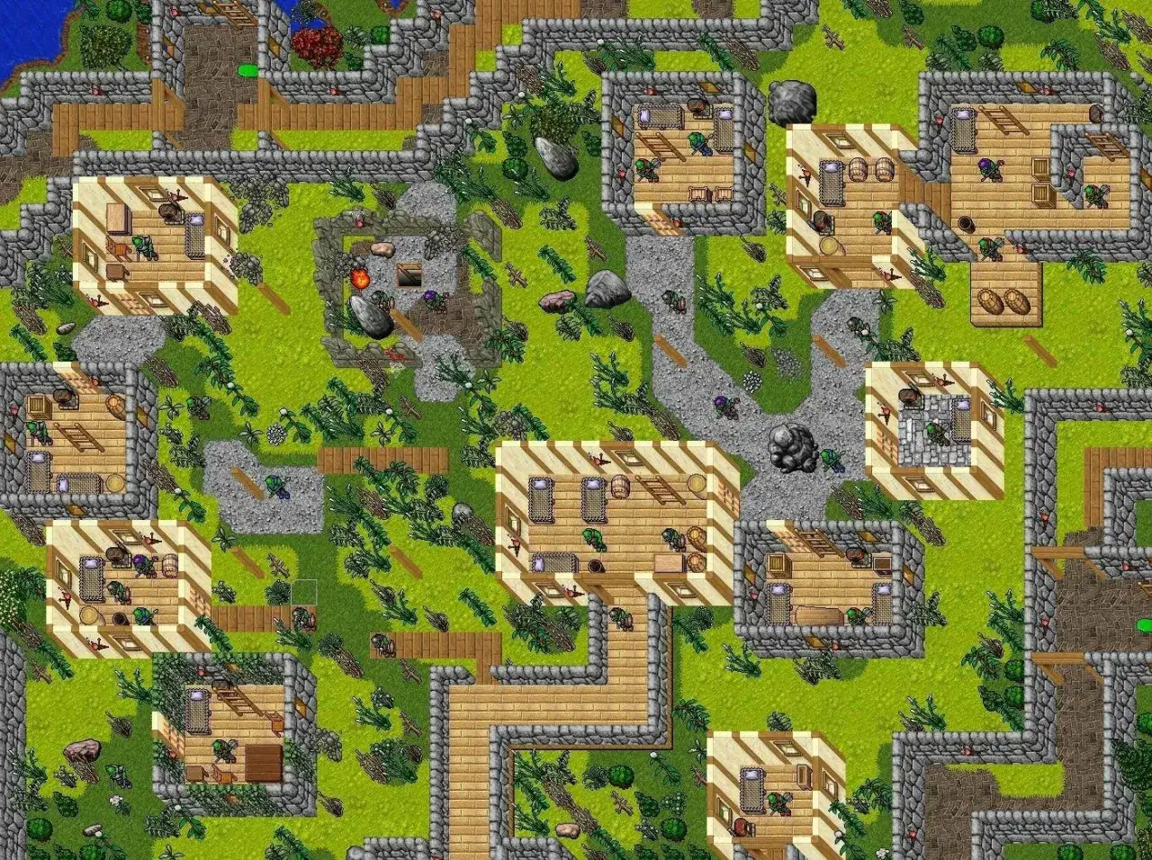 Widok z lotu ptaka na wioskę w grze tibia. Widać drewniane domy, kamienne mury, ścieżki i zieloną trawę.