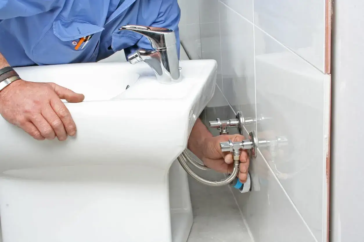 Fontanero desconectando las tuber&iacute;as para quitar bidet.