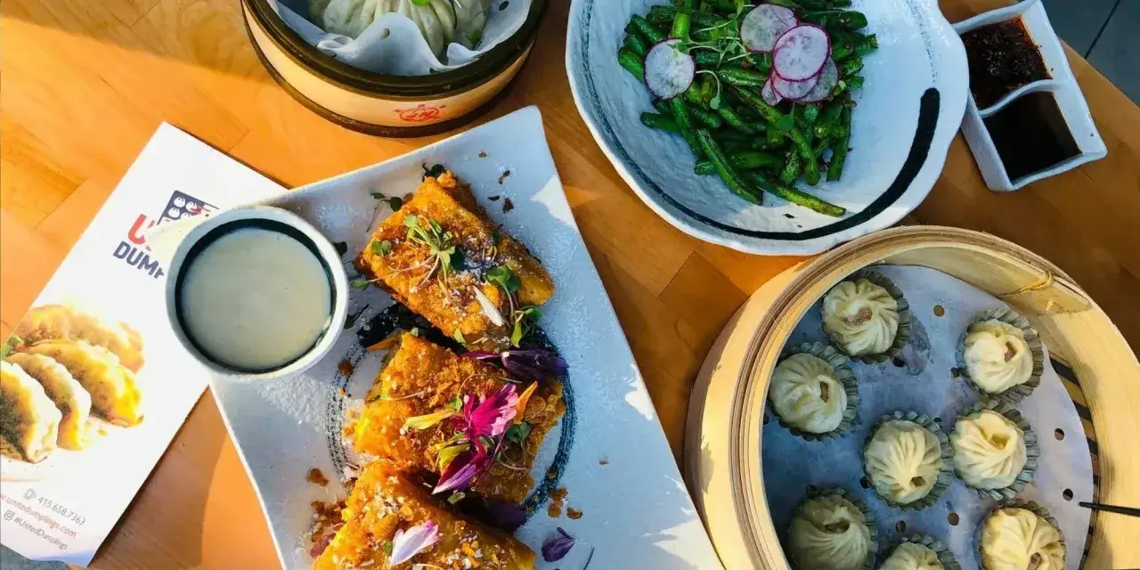 Knusprige Gyoza als Beilage, daneben ged&auml;mpfte Teigtaschen, gr&uuml;ne Bohnen und ein Dip.