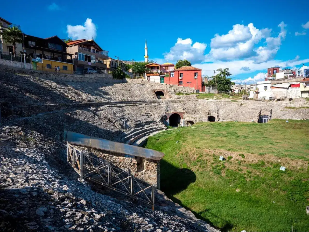Starożytny amfiteatr w Durr&euml;s, Albania, z widokiem na miasto i meczet.