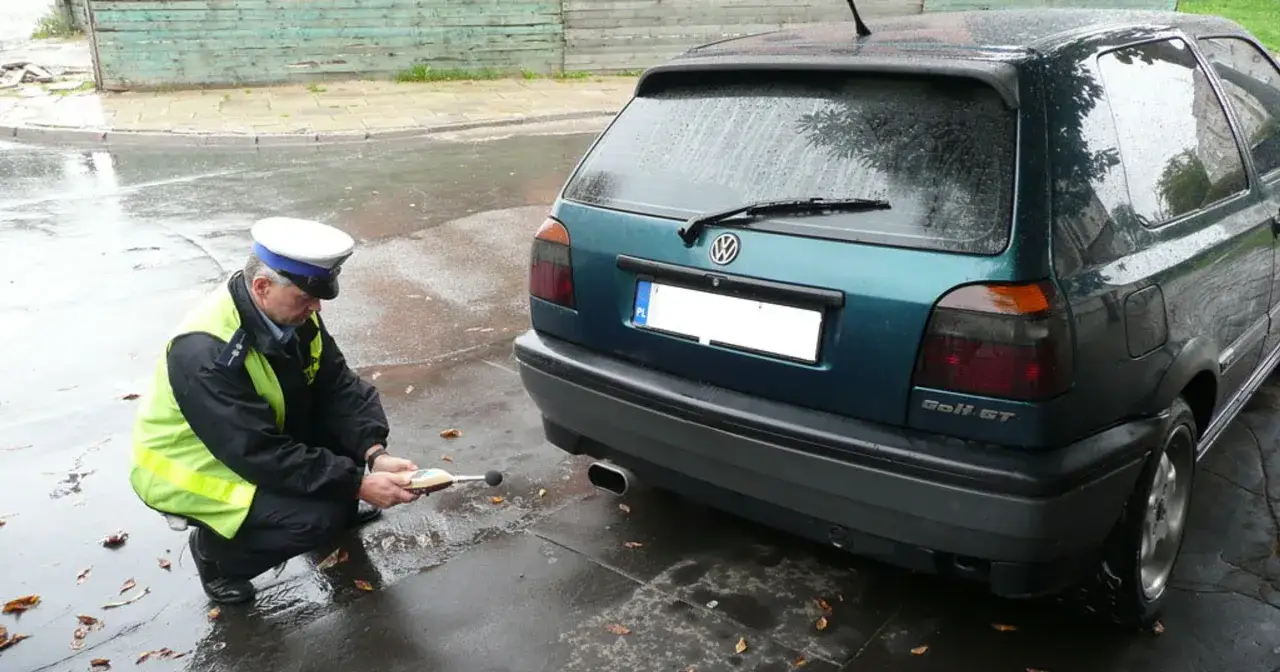 Policjant mierzy poziom hałasu z wydechu Golfa GT. Sprawdza, ile decybeli może mieć auto.