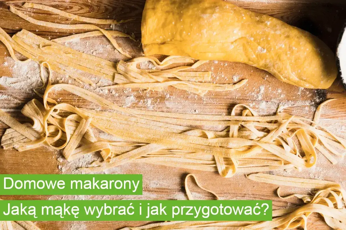 Domowy makaron, świeżo przygotowany, leży obok ciasta na drewnianej desce. Różnica między domowym makaronem a kupnym ze sklepu jest widoczna.