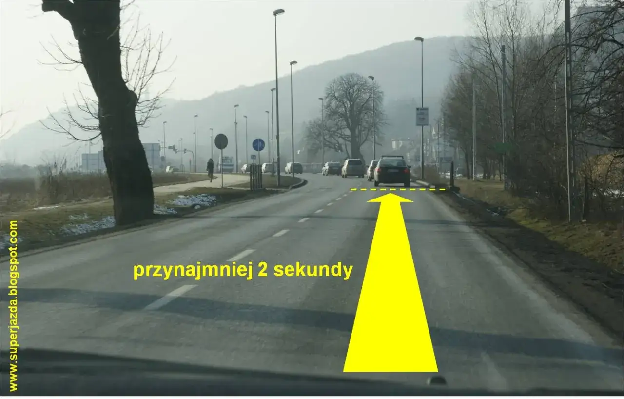 Jazda za samochodem z zachowaniem zasady 3 sekund. Żółta strzałka i napis 