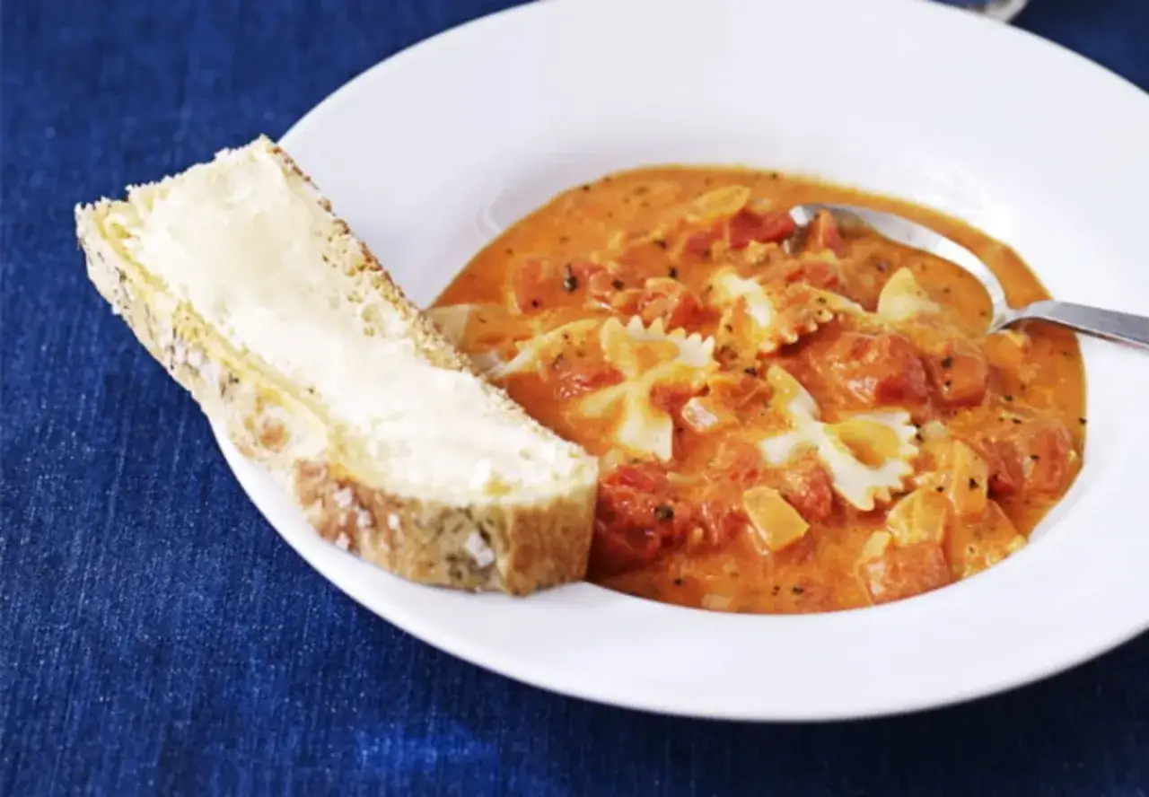 En kr&auml;mig tomatsoppa med fj&auml;rilspasta, perfekt f&ouml;r ett snabbt tomatsoppa recept. Serveras med en skiva sm&ouml;rg&aring;s.
