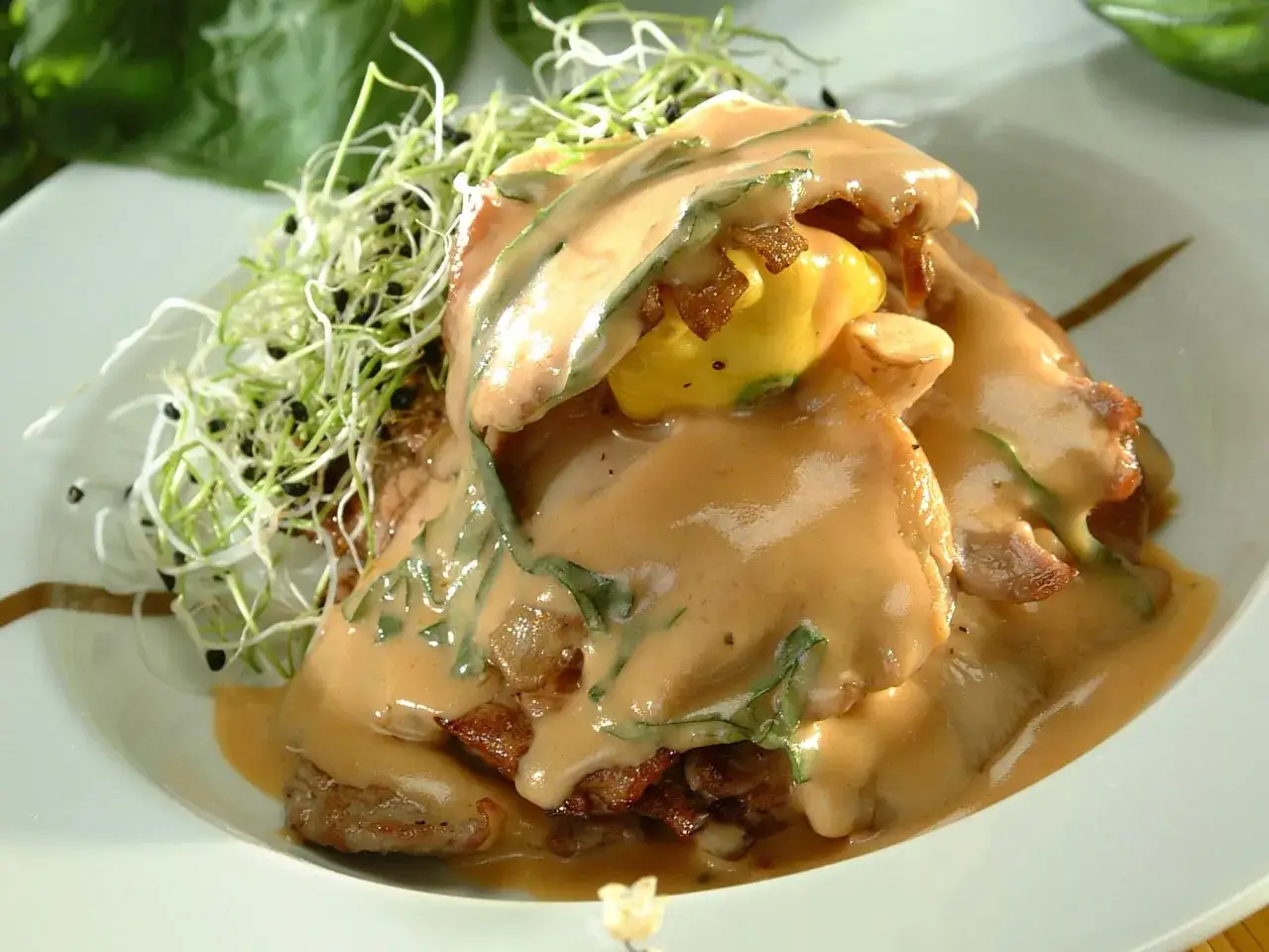 Délicieuse escalope de veau nappée d'une sauce onctueuse, garnie de pousses fraîches et de quelques éclats croustillants.