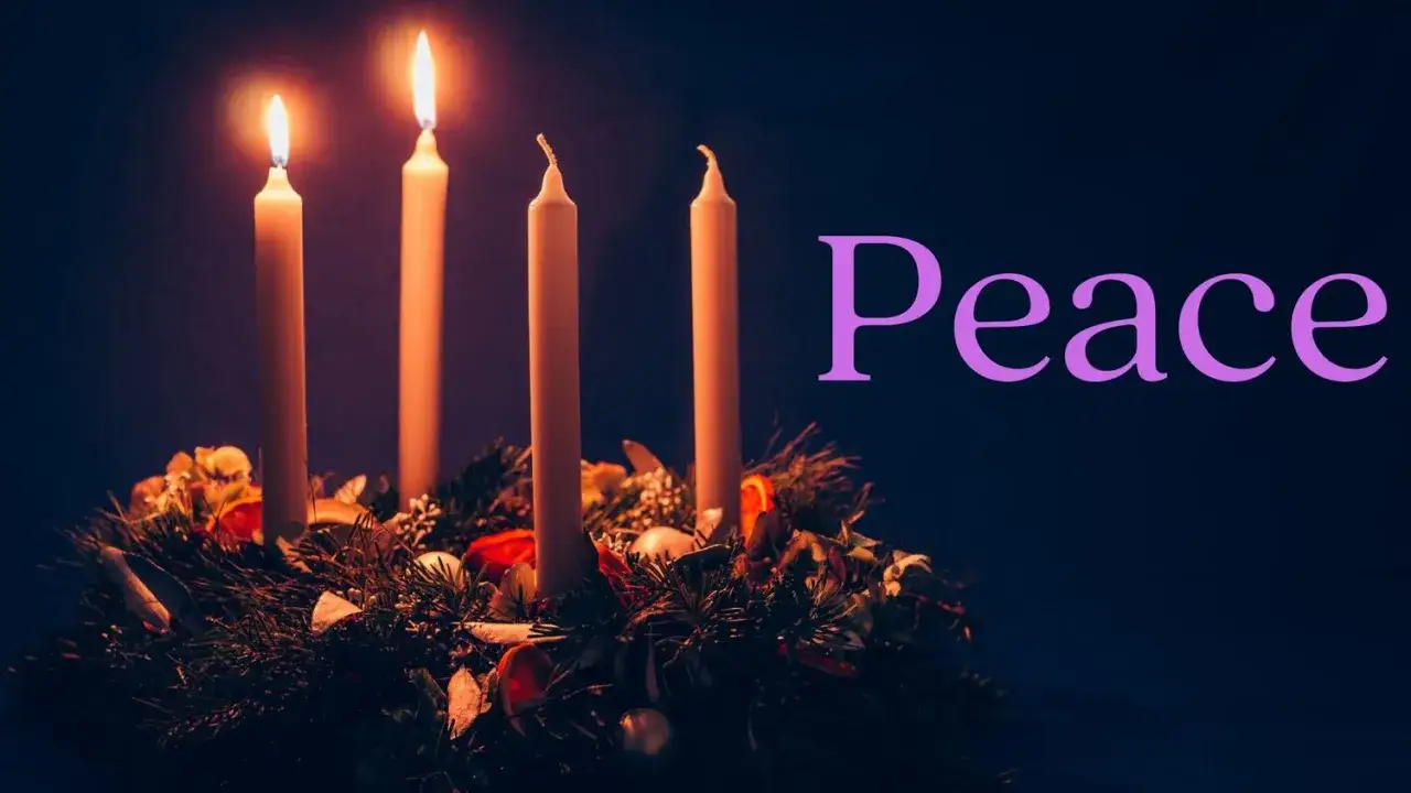 Two candles burn on an Advent wreath, symbolizing the second week of Advent and the hope for peace.