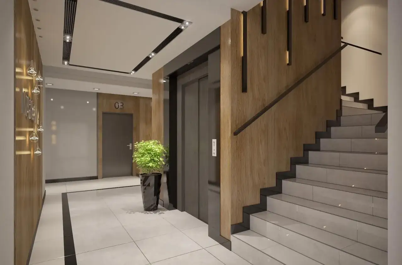 Hall d'entrée d'un immeuble moderne avec un ascenseur, un escalier en béton et bois, et des éclairages design.