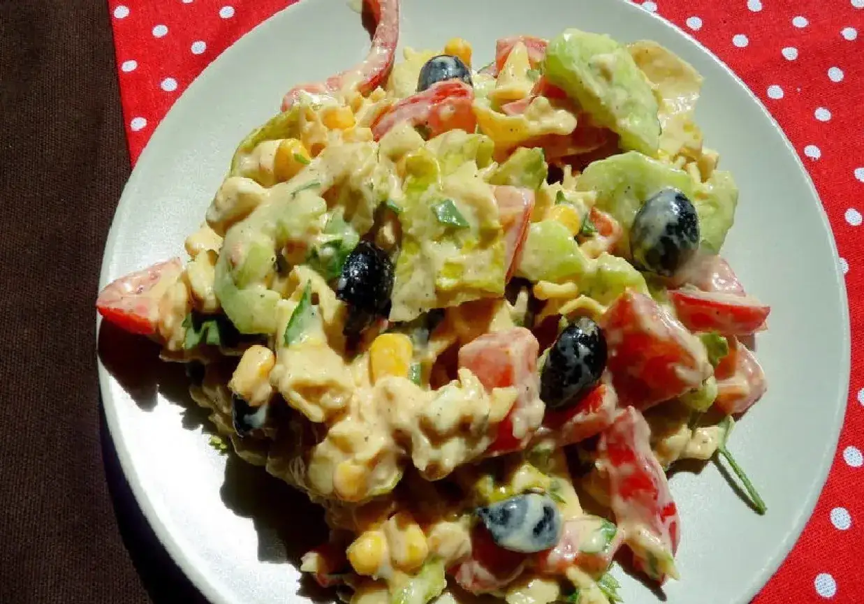 Kolorowa sałatka z makaronem, pomidorami, ogórkiem, kukurydzą i oliwkami w kremowym sosie. Idealna na letnie dni, inspiracja do gorgonzola przepisy.