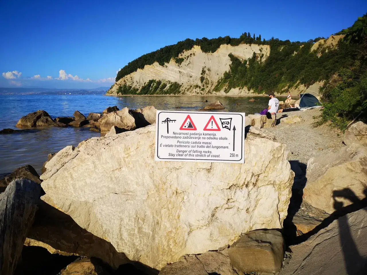 Skały nad wodą, znak ostrzegawczy 