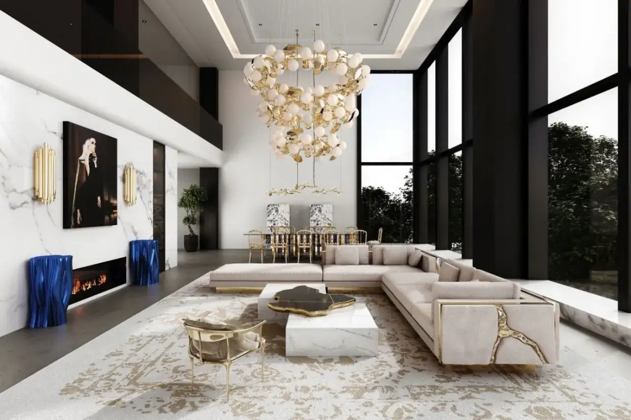 Luksusowy salon z imponującym żyrandolem, który jest jednym z wielu rodzajów lamp sufitowych. Obok jadalnia i designerska sofa.
