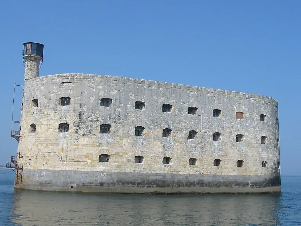 Fort Boyard, imponująca twierdza na morzu, z licznymi oknami i wieżą.