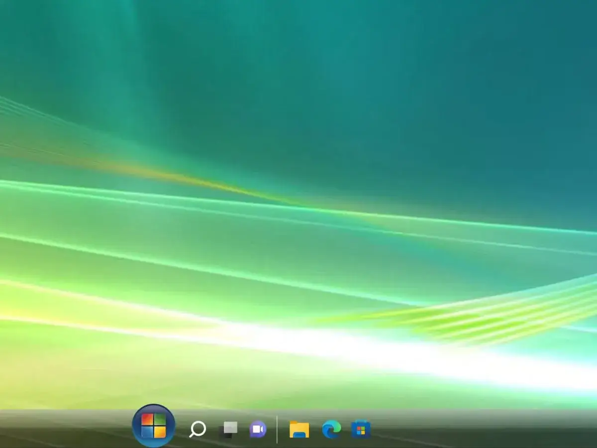 Pulpit systemu Windows Vista z charakterystyczną tapetą Aurora i paskiem zadań z ikonami.