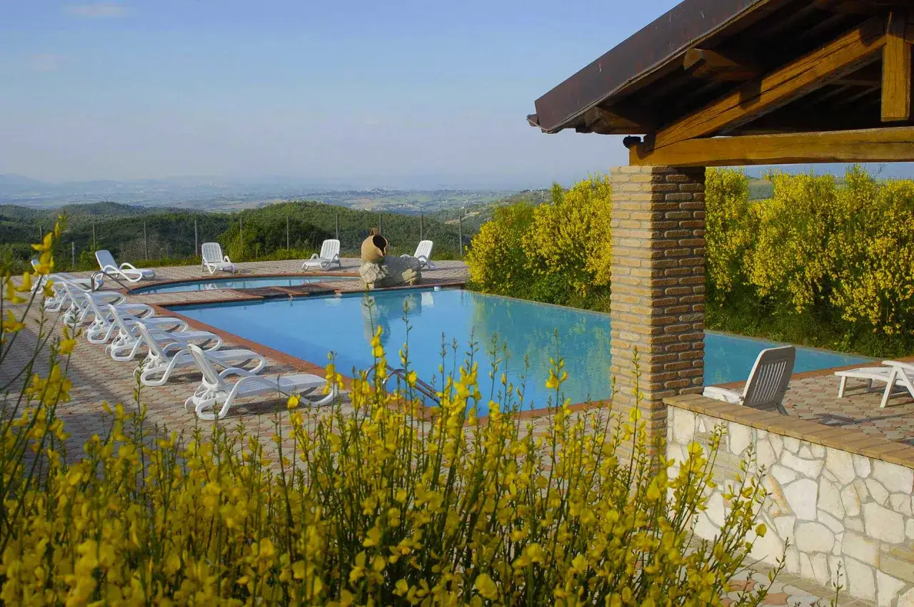 Piscina con vista panoramica in Umbria, ideale per agriturismi pet friendly. Relax e natura per tutta la famiglia.