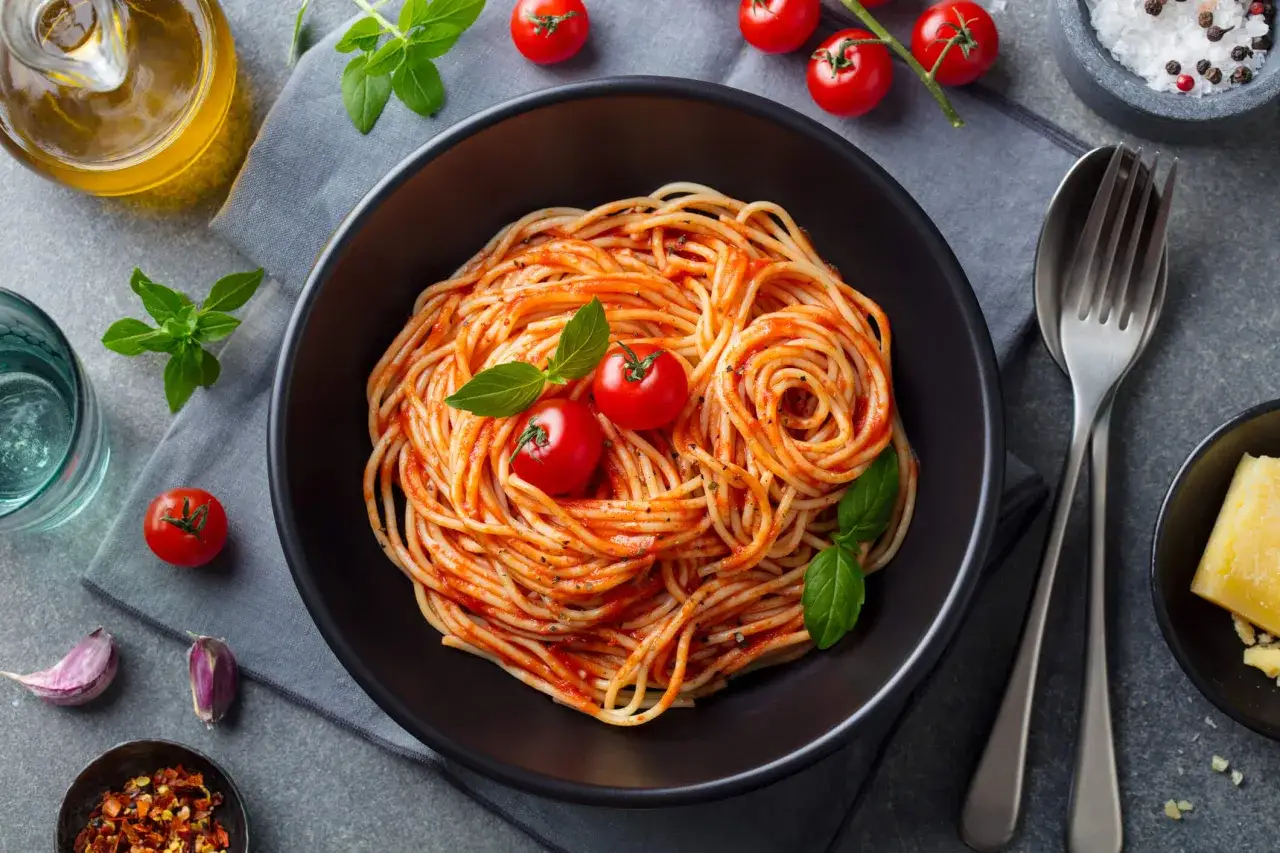 Spaghetti al pomodoro, un piatto gustoso che pu&ograve; rientrare in un regime alimentare attento alla glicemia, con pomodori freschi e basilico.