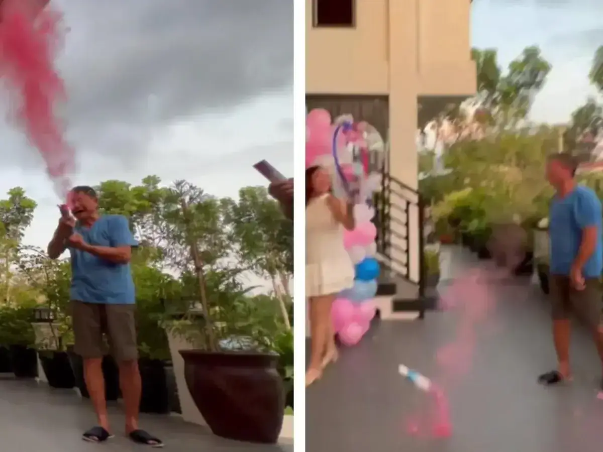 Mann mit entt&auml;uschtem Gesichtsausdruck, als rosa Rauch bei einer Gender-Reveal-Party aufsteigt.